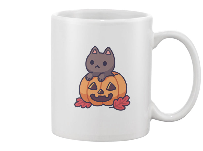 Cute Black Cat In Carved Pumpkin Mug -Image by Shutterstock